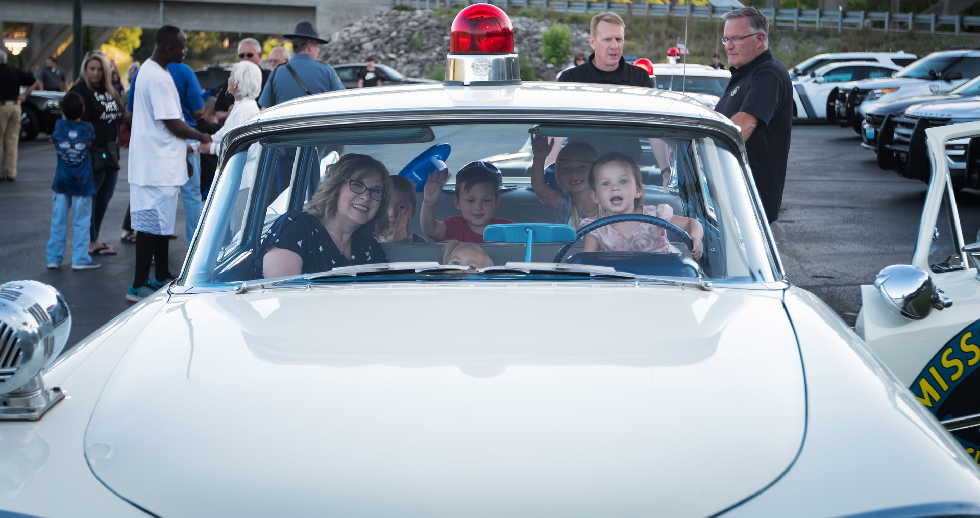 kids in classic police car